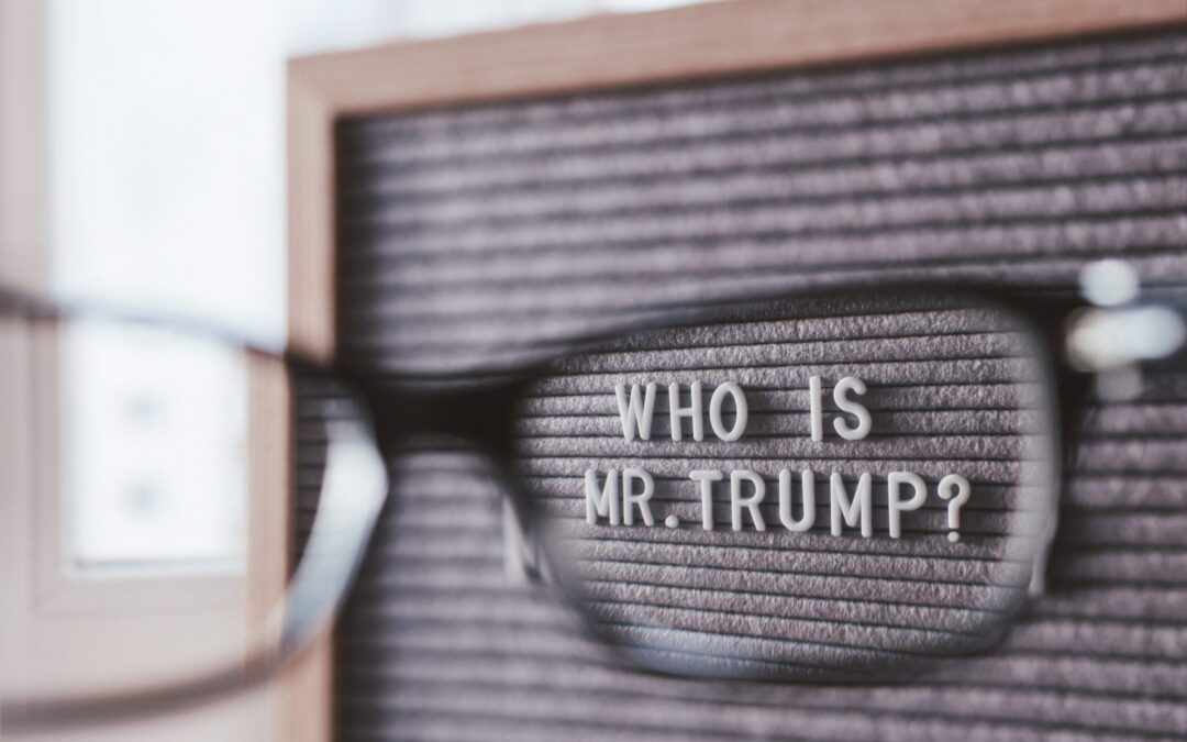 Letterboard with question WHO IS MR.TRUMP? through eyeglasses. C